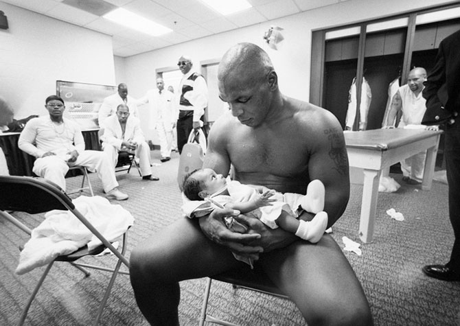 Mike Tyson cradles his 2-month-old son Miguel in his arms after losing the 2002 WBC/ IBF/ IBO Heavyweight Title fight to Lennox Lewis at the Pyramid Arena.  Memphis, Tennessee 6/8/2002 (Image # 2109 )