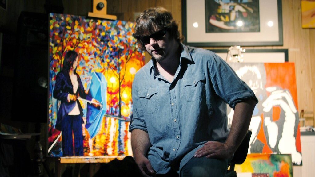 Կույր նկարիչ Ջոն Բրեմբլիթը իր նկարի մոտ։